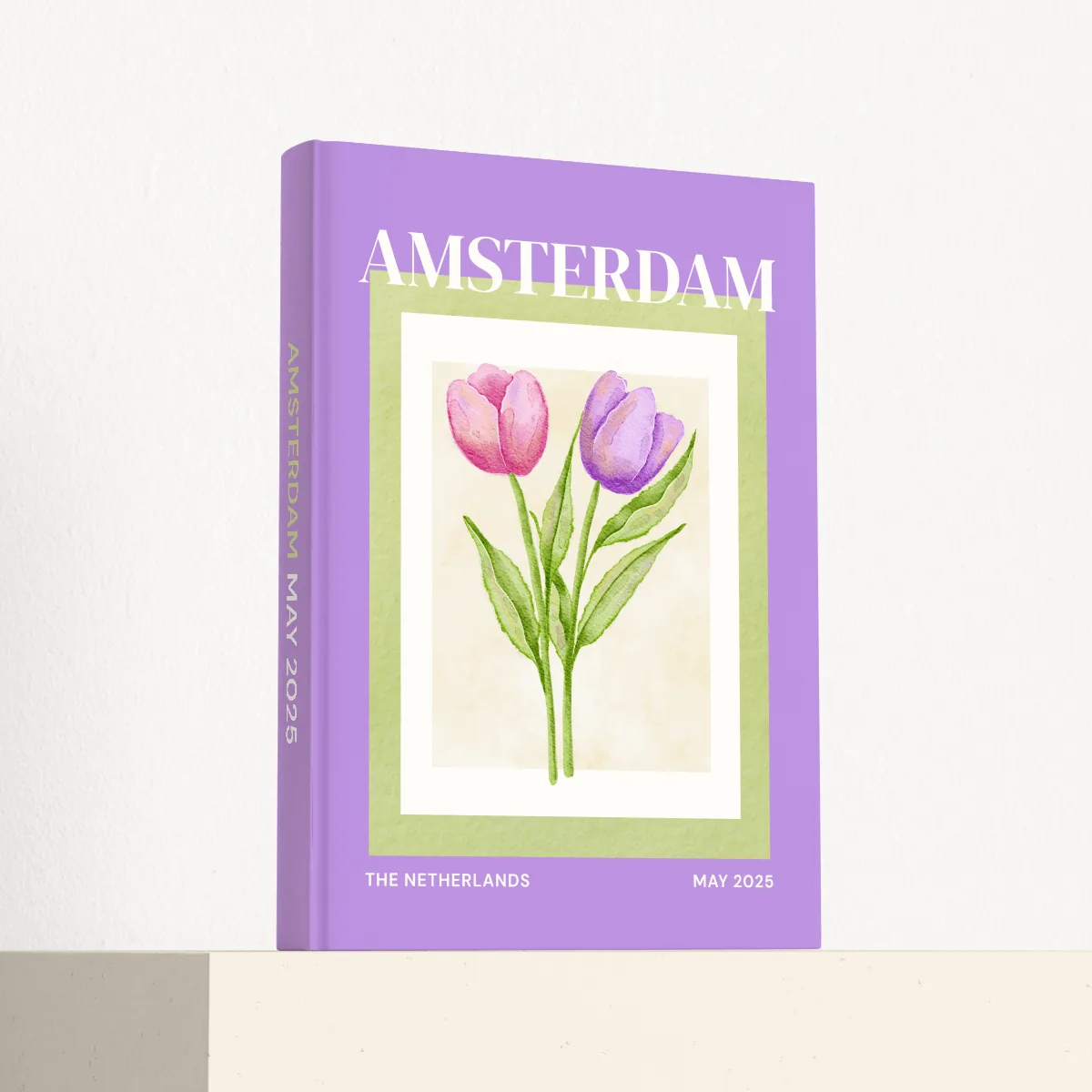 Amsterdam travel photobook standing at an angle, showing the printed spine and matte hardcover