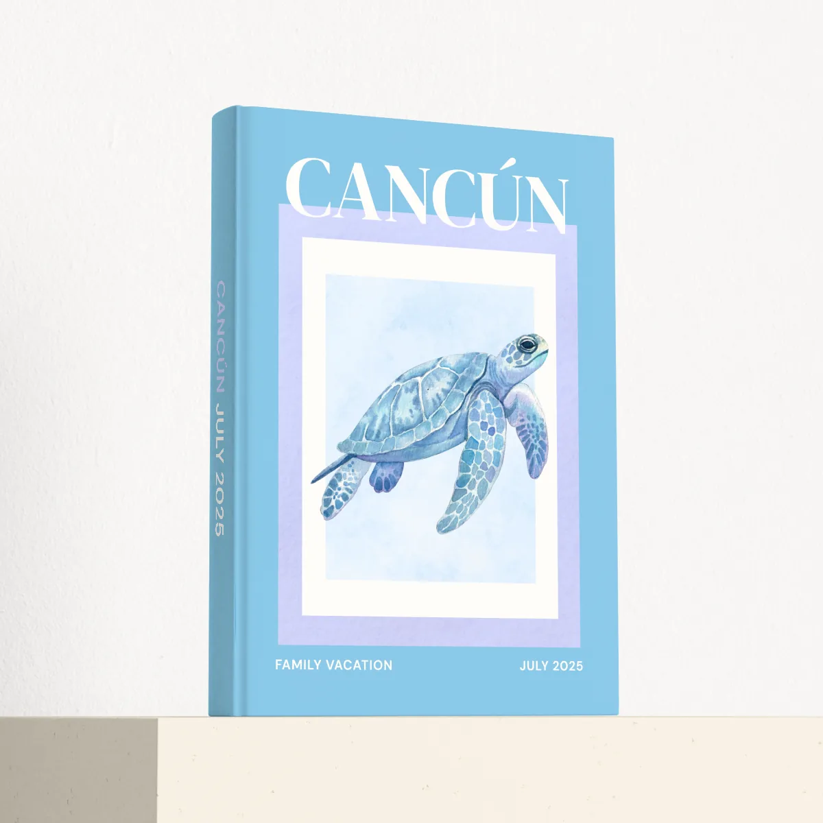 Cancún travel photobook standing at an angle, showing the printed spine and matte hardcover