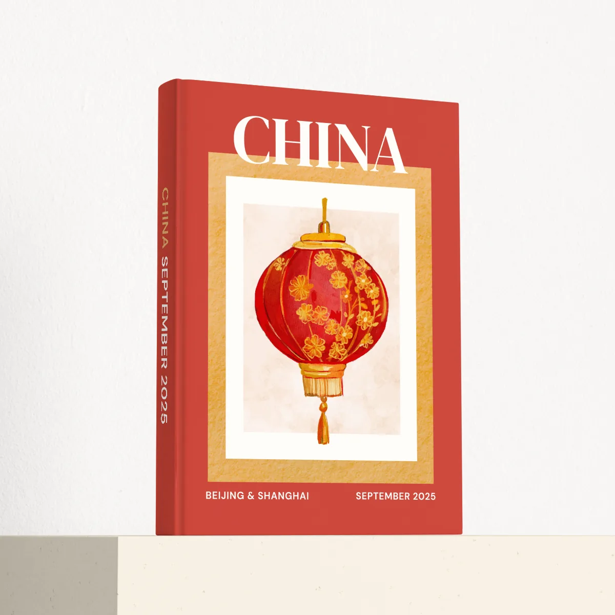 China travel photobook standing at an angle, showing the printed spine and matte hardcover