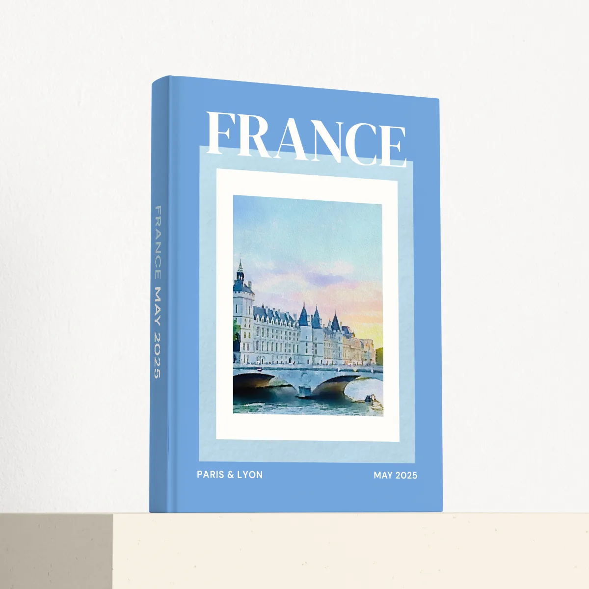 France travel photobook standing at an angle, showing the printed spine and matte hardcover