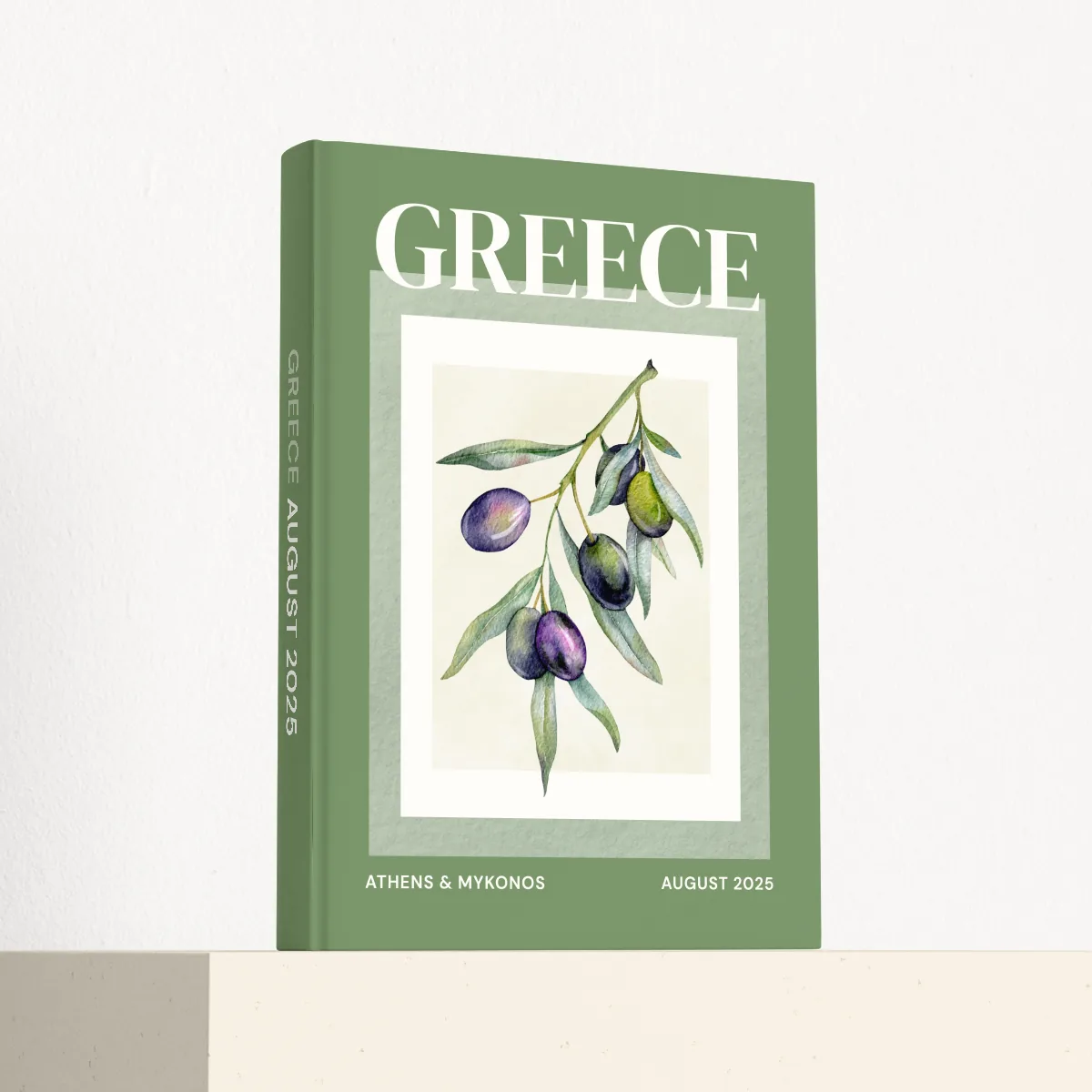 Greece travel photobook standing at an angle, showing the printed spine and matte hardcover
