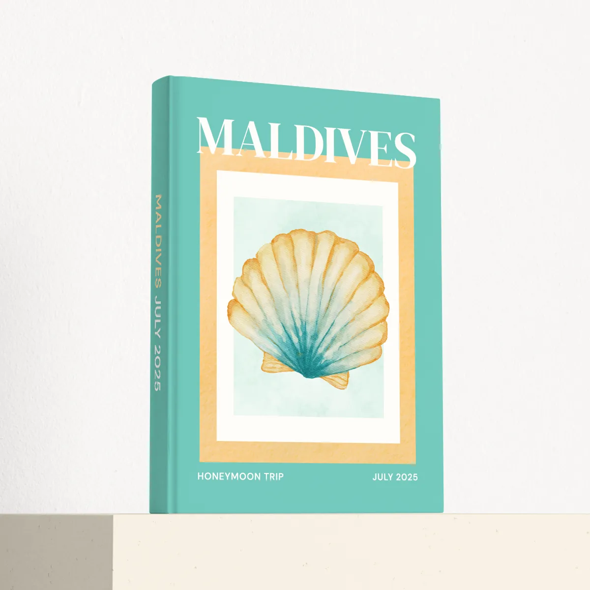 Maldives travel photobook standing at an angle, showing the printed spine and matte hardcover