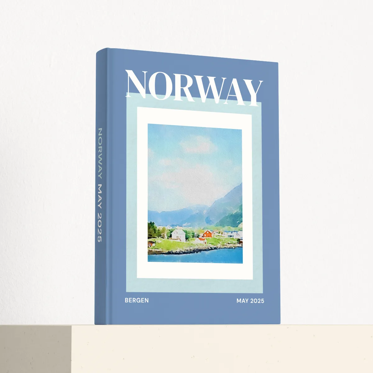 Norway travel photobook standing at an angle, showing the printed spine and matte hardcover