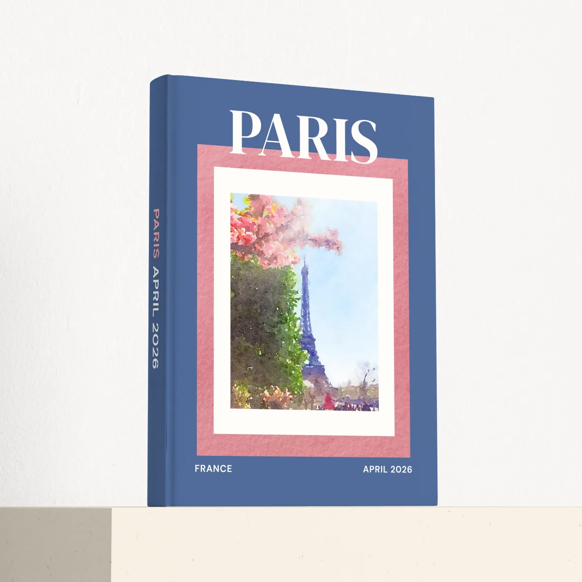 Paris travel photobook standing at an angle, showing the printed spine and matte hardcover