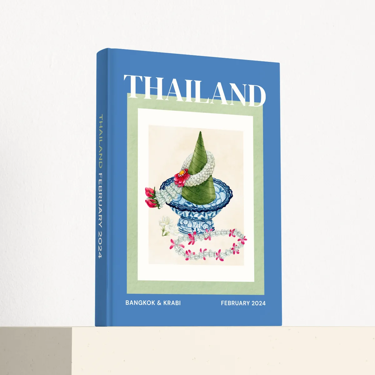 Thailand travel photobook standing at an angle, showing the printed spine and matte hardcover